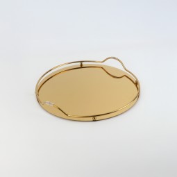 Round serving tray with a mirrored surface and gold frame