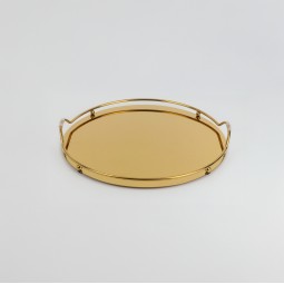 Round serving tray with a mirrored surface and gold frame