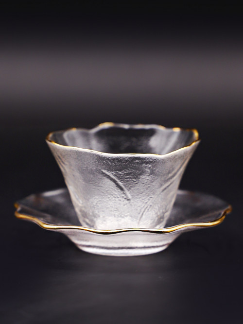 Clear glass cup with golden rim