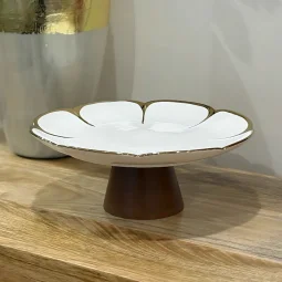 Ceramic serving plate with a white wooden base and golden edges - circular - large